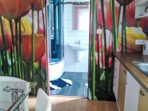 a bathroom with a toilet and a sink and a mirror at Apartment Jiřetínská chaloupka by Interhome in Jiřetín pod Jedlovou