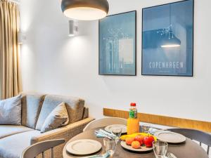 a living room with a table and a couch at Apartment Seeruhe by Interhome in Lembruch