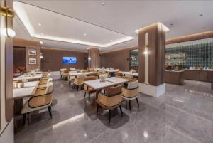 a dining room with tables and chairs in a restaurant at Atour Hotel Beijing Nanluoguxiang Beixinqiao Subway Station in Beijing