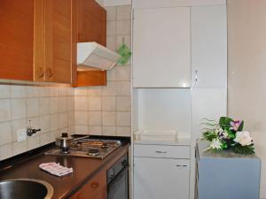 een keuken met een witte koelkast en een spoelbak bij Studio Vista Lago by Interhome in Ruvigliana