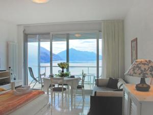 a living room with a view of the ocean at Studio Vista Lago by Interhome in Castagnola