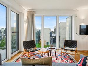 a living room with a view of a city at Apartment Seeflair by Interhome in Lembruch +22 photos
