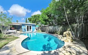 a swimming pool in the backyard of a house at The Perfect South Florida Experience in Fort Lauderdale