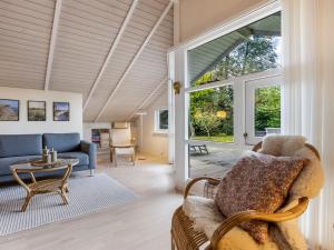 a living room with a couch and a table at Holiday Home Lirim - 400m from the sea by Interhome in Marielyst