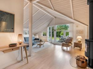 a living room with a couch and a table at Holiday Home Lirim - 400m from the sea by Interhome in Marielyst