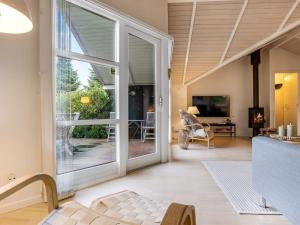 an open living room with sliding glass doors at Holiday Home Lirim - 400m from the sea by Interhome in Marielyst +14 photos