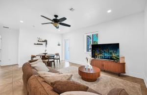 a living room with a couch and a flat screen tv at The Perfect South Florida Experience in Fort Lauderdale