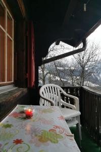 a table and two chairs on a balcony with a candle at Apartment Sandgrube 2- OG Süd by Interhome in Mörel