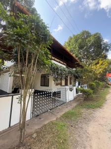 a house with a fence in front of it at Urban Minz in Mūvattupula +6 photos