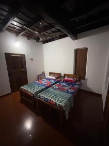 a bedroom with two beds in a room at Urban Minz in Mūvattupula