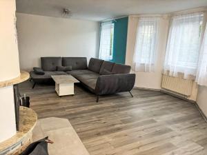 a living room with a couch and a table at Holiday Home Hostyn Hills by Interhome in Bystřice pod Hostýnem