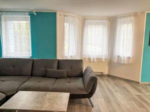 a living room with a couch and a table at Holiday Home Hostyn Hills by Interhome in Bystřice pod Hostýnem