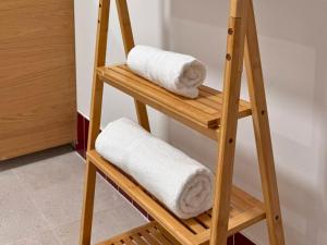 a wooden ladder with towels on it in a bathroom at Ruzafa & Oceanografic Suites by Illetes Flats in Valencia +56 photos