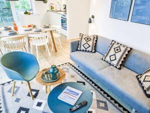 a living room with a blue couch and a table at Apartment Fiddy by Interhome in Lembruch