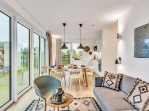 a living room with a couch and a table at Apartment Fiddy by Interhome in Lembruch +21 photos