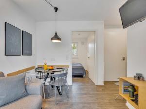 a living room with a couch and a table at Apartment Seetraum by Interhome in Lembruch