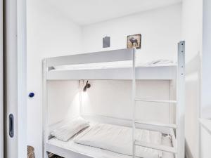 a room with white walls and bunk beds at Apartment Seewind by Interhome in Lembruch