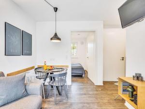 a living room with a couch and a table at Apartment Seewind by Interhome in Lembruch +12 photos