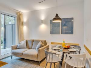 a living room with a chair and a table at Apartment Seetraum by Interhome in Lembruch