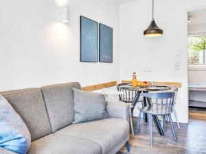 a living room with a couch and a table at Apartment Seewind by Interhome in Lembruch