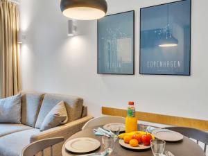 a living room with a table and a couch at Apartment Seetraum by Interhome in Lembruch +25 photos