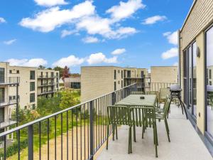 a balcony with a table and chairs and buildings at Apartment Seezauber by Interhome in Lembruch