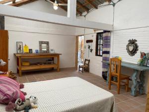 a bedroom with a bed and a table in a room at Casa Kata in Zipolite