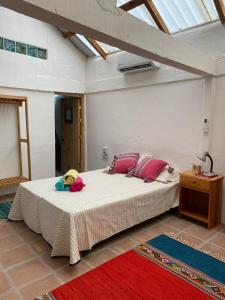 a bedroom with a bed with a stuffed animal on it at Casa Kata in Zipolite