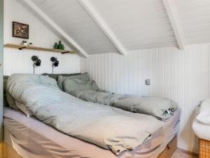 a room with four pillows on a bed at Holiday Home Else - 470m from the sea by Interhome in Østerby Havn