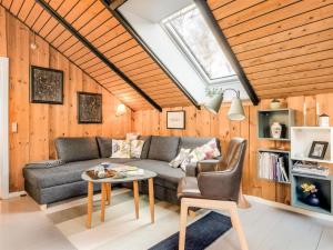 a living room with a couch and a table at Holiday Home Else - 470m from the sea by Interhome in Østerby Havn