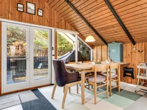 a dining room with a wooden table and chairs at Holiday Home Else - 470m from the sea by Interhome in Østerby Havn