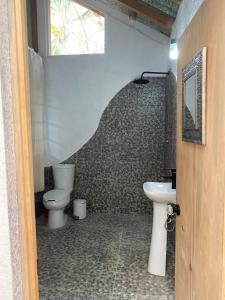 a bathroom with two toilets and a sink at Casa Kata in Zipolite +22 photos