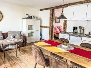 a kitchen and dining room with a wooden table and chairs at Apartment Therese by Interhome in Mirow +14 photos