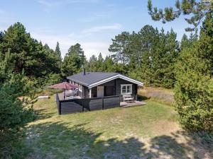 a small cabin in the middle of a yard at Holiday Home Reinhardt - 800m from the sea by Interhome in Mølby