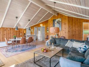 a living room with a couch and a table at Holiday Home Bole - 10km from the sea by Interhome in Øster Vrøgum
