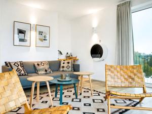 a living room with a couch and chairs at Apartment Penthouse Seeblick by Interhome in Lembruch