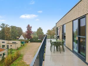 a balcony of a house with a table and chairs at Apartment Penthouse Seeblick by Interhome in Lembruch