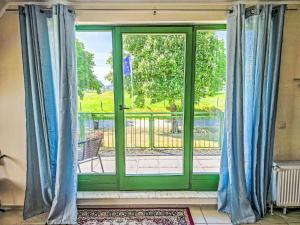 a sliding glass door with a view of a balcony at Apartment Wariner Straße by Interhome in Tempzin