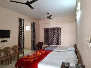 a bedroom with a bed and a table and chairs at Vidara Budget Stay in Trivandrum