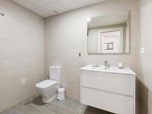 a bathroom with a toilet and a sink and a mirror at Holiday Home Green Garden II-2 by Interhome in Pilar de la Horadada