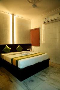 a bedroom with a large bed in a room at Ilah residency in Chennai +8 photos