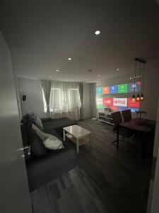 a living room with a couch and a table at Stylish Home Theater Apartment 3 in Kreuztal