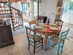 a dining room with a wooden table and chairs at Holiday Home La Longère by Interhome in Trémaouézan