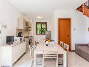 a kitchen and dining room with a table and chairs at Apartment Borgo Castello-9 by Interhome in Argegno