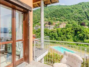 a balcony with a view of a swimming pool at Apartment Borgo Castello-9 by Interhome in Argegno