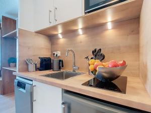 a kitchen with a bowl of fruit on a counter at Studio Les Olympiades-16 by Interhome in Val Thorens