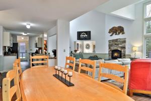 a kitchen and living room with a table and a couch at Renovated 4BR House - Hot Tub, Game Room & Fire Pit - 11 Mins to Killington Lifts & Dining in Telemark Village