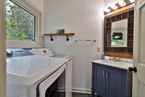 a bathroom with a washing machine and a sink at Renovated 4BR House - Hot Tub, Game Room & Fire Pit - 11 Mins to Killington Lifts & Dining in Telemark Village +40 photos