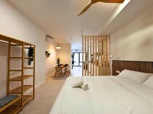 a bedroom with a white bed and a room with a table at Ruzafa & Oceanografic Suites by Illetes Flats in Valencia