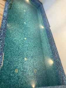 a swimming pool with a blue tiled floor at Villa funk monk - swimming pool in Kuilapayam +18 photos